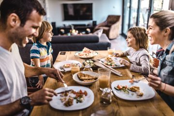 En familie som spiser lunsj sammen rundt et middagsbord